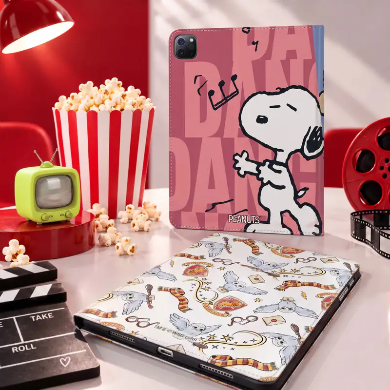 Peanuts Snoopy tablet folio and laptop sleeve with popcorn on a red film set